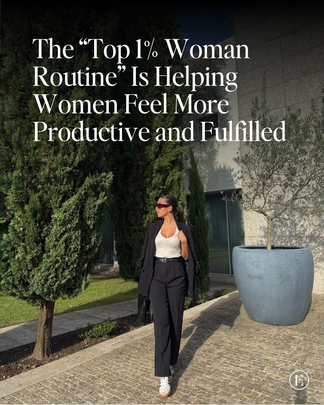 A woman in a black suit and white top walks outside next to large potted plants; text overlay discusses a “Top 1% Woman Routine” for productivity and fulfillment.