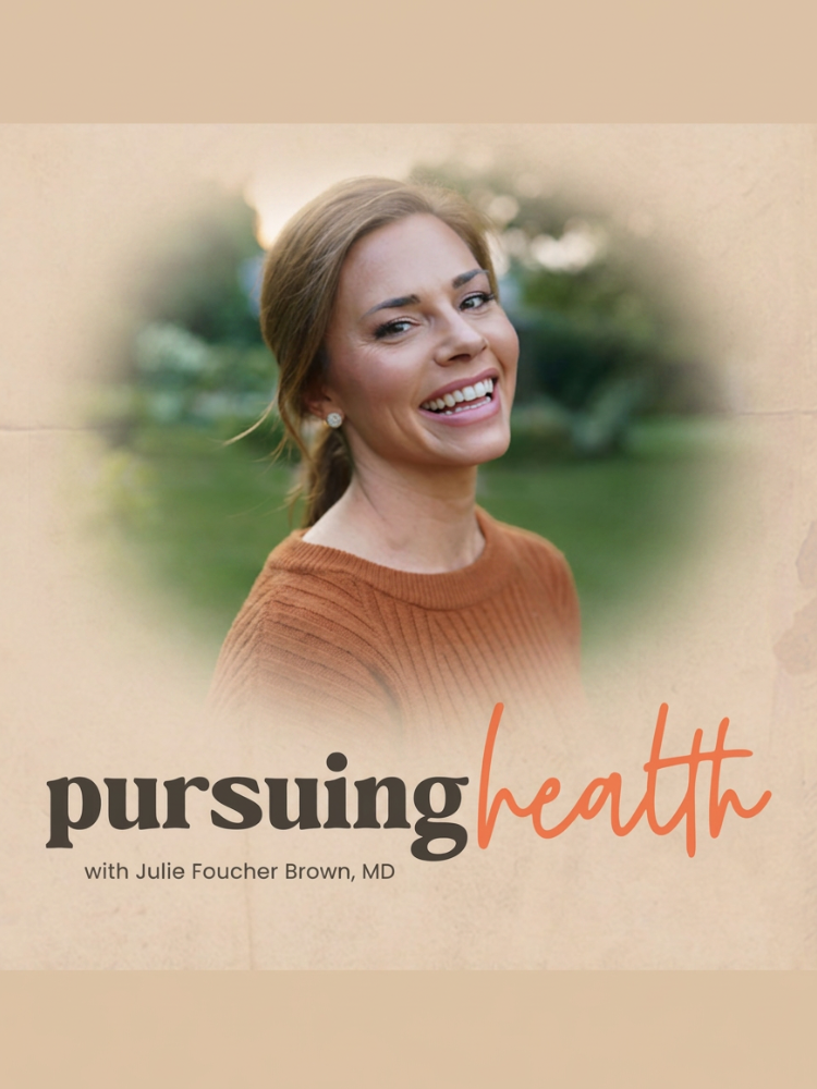 A woman with light brown hair smiles outdoors; text reads "pursuing health with Julie Foucher Brown, MD" in bold and script fonts on a beige background.