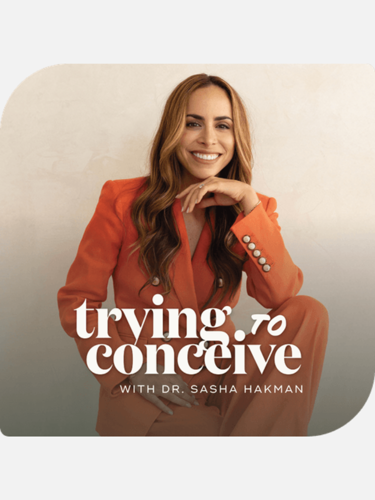 A woman in an orange suit sits and smiles at the camera. Text reads: "trying to conceive with Dr. Sasha Hakman.