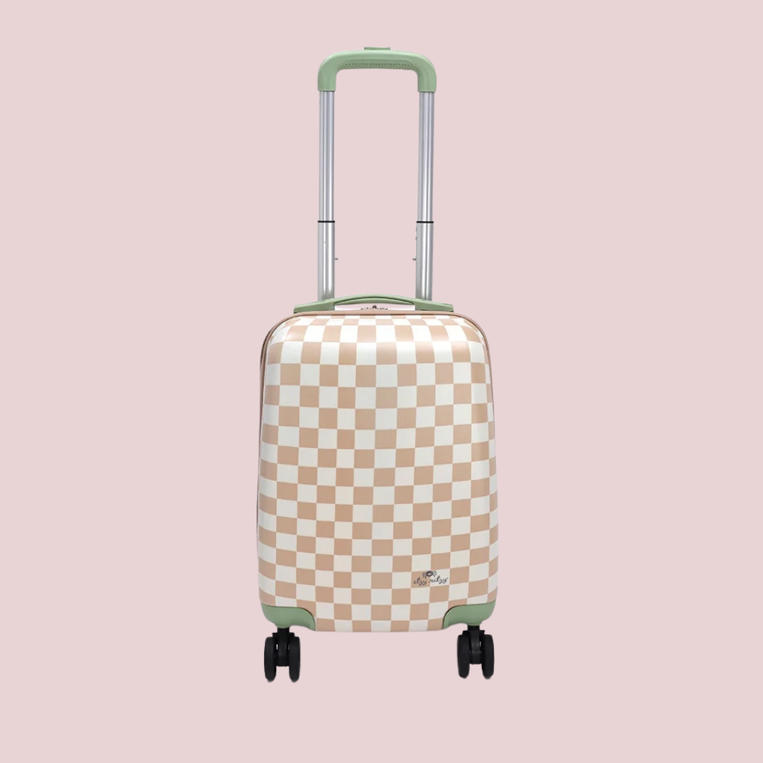 A beige and white checkered rolling suitcase with four wheels and an extended green handle, set against a plain pink background.