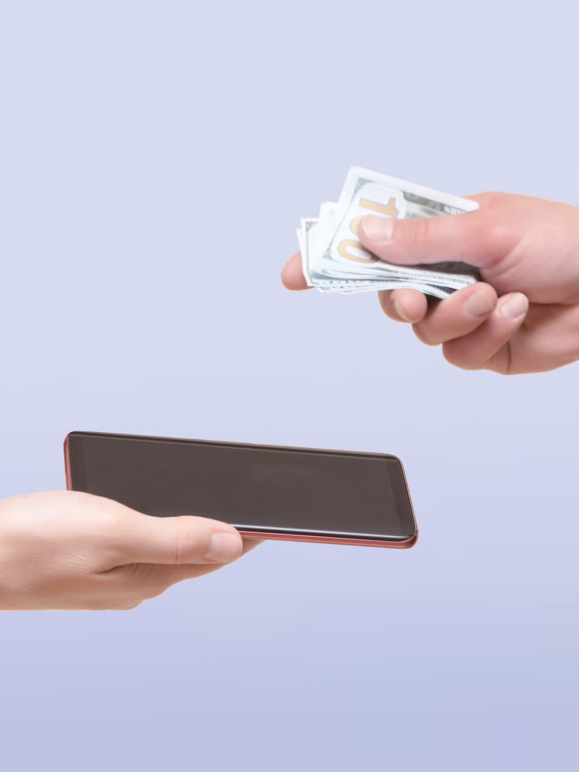 One hand offers cash while another holds a smartphone, suggesting an exchange or transaction against a plain light background.