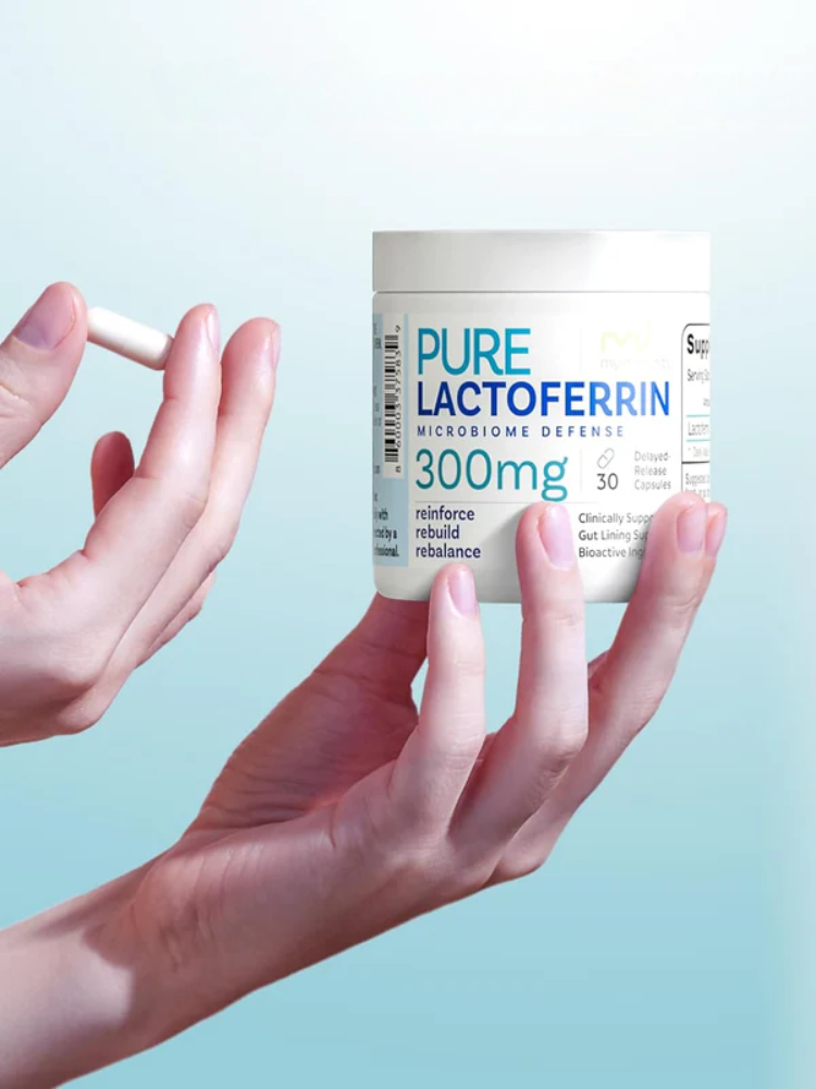A hand holds a white capsule while another hand holds a container labeled "Pure Lactoferrin 300mg Microbiome Defense" against a light blue background.