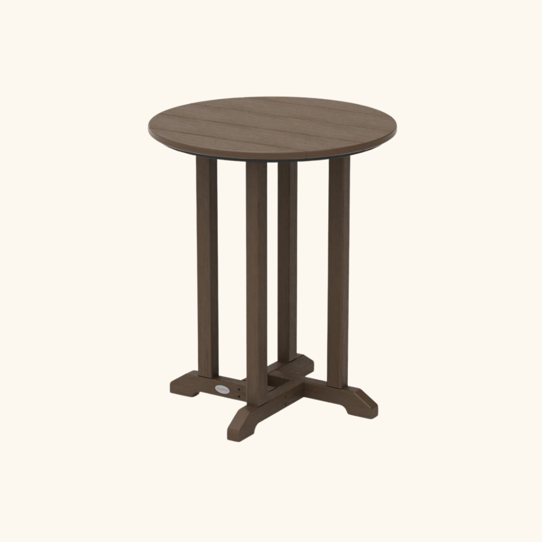 A small, round, brown wooden table with four vertical legs and a sturdy crossbar base, set against a plain light background.