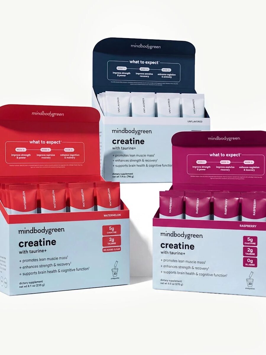 Three boxes of mindbodygreen creatine supplement packets in different flavors: watermelon, unflavored, and raspberry, displayed upright with open lids showing individual sticks inside.