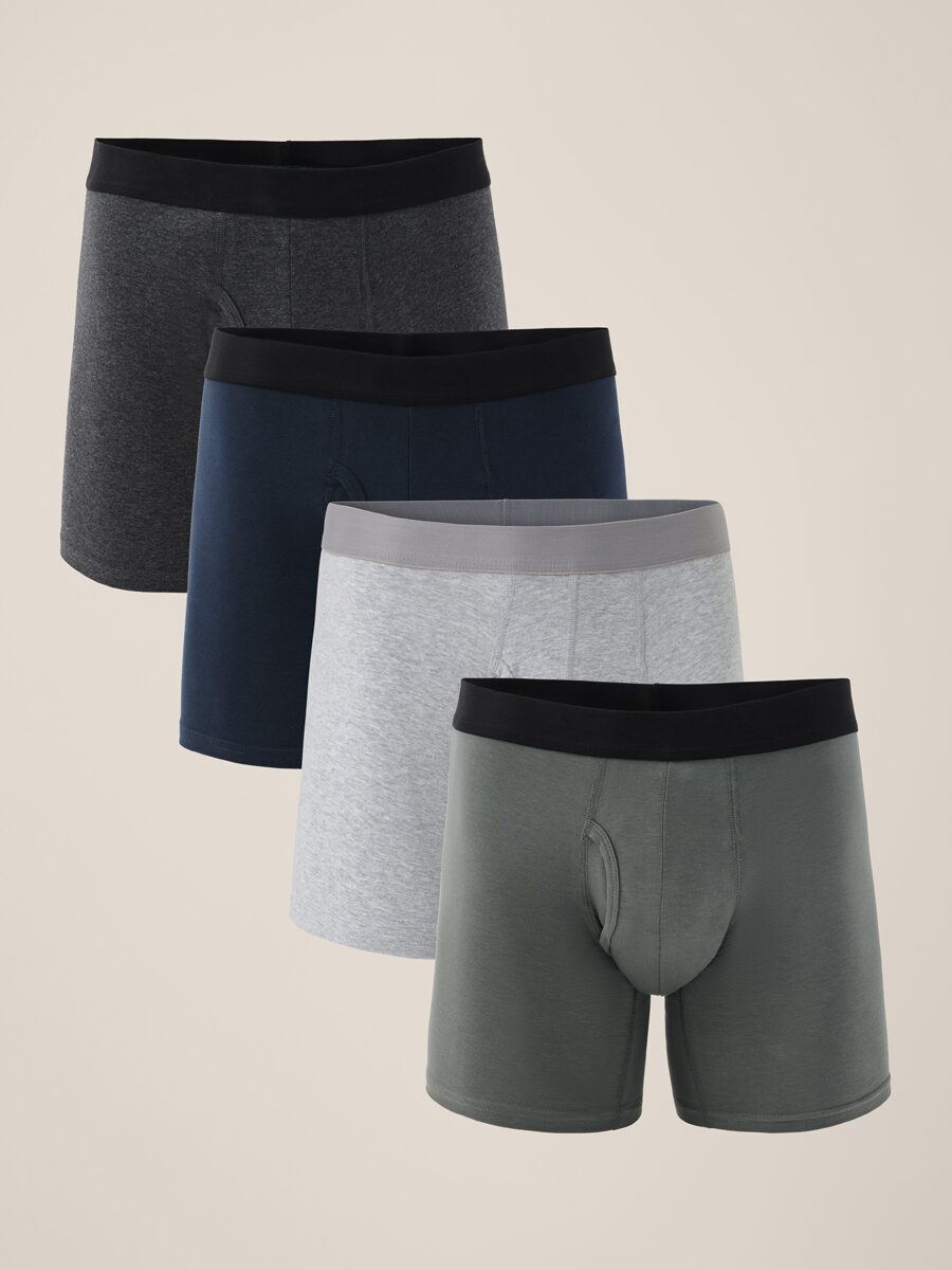 Four pairs of men's boxer briefs in dark gray, navy blue, light gray with a gray waistband, and olive green colors, arranged in a row.