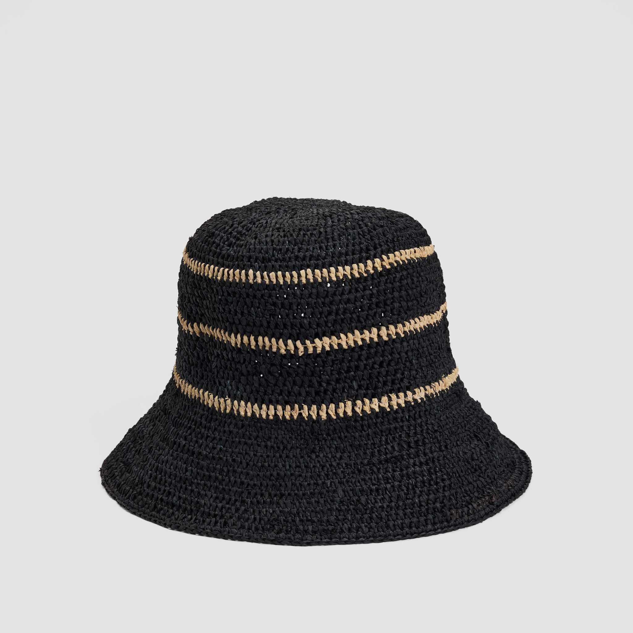 Black woven bucket hat with three horizontal tan stripes on a plain light gray background.
