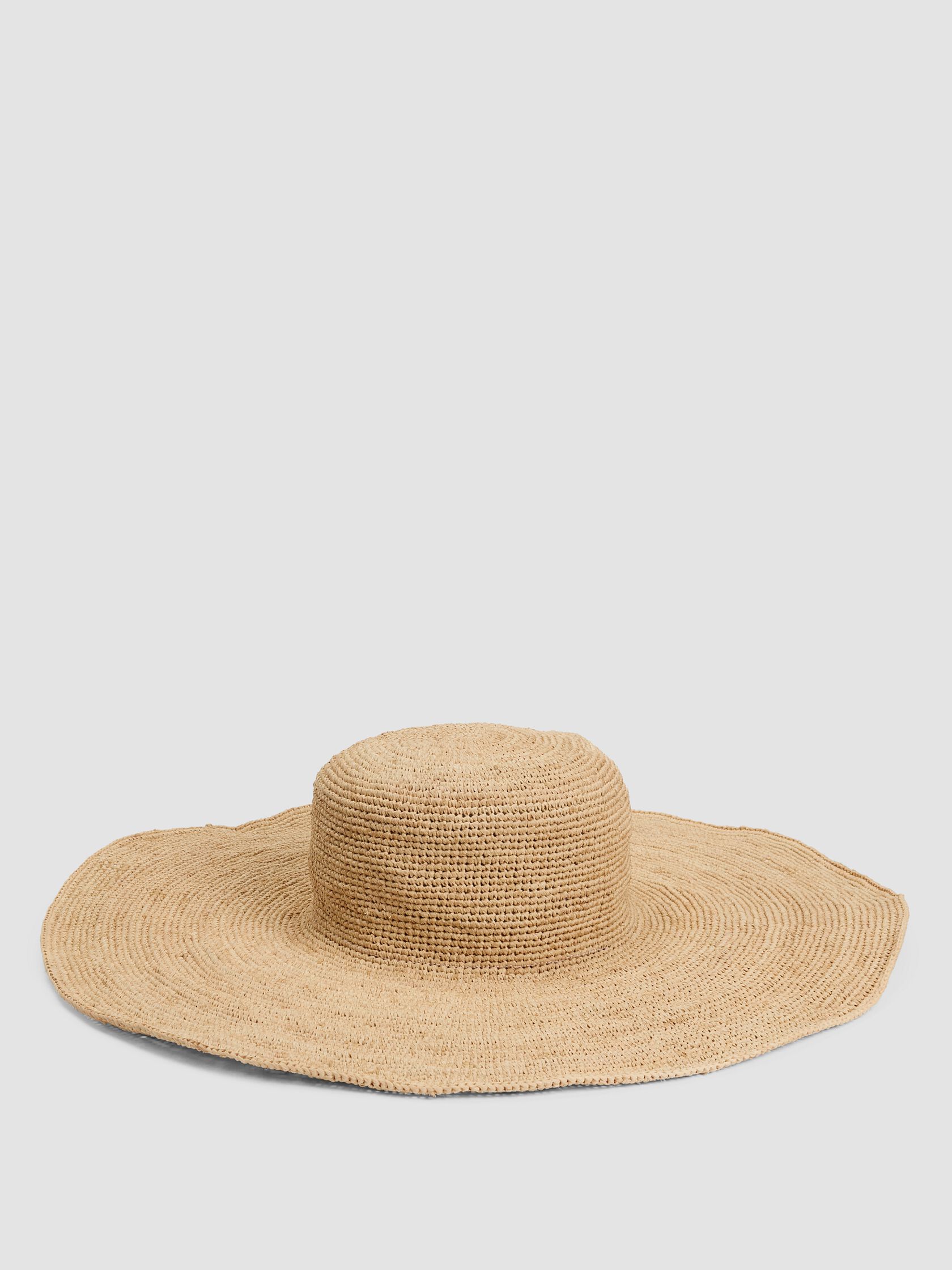 Wide-brimmed natural straw hat with a round crown, displayed on a plain white background.