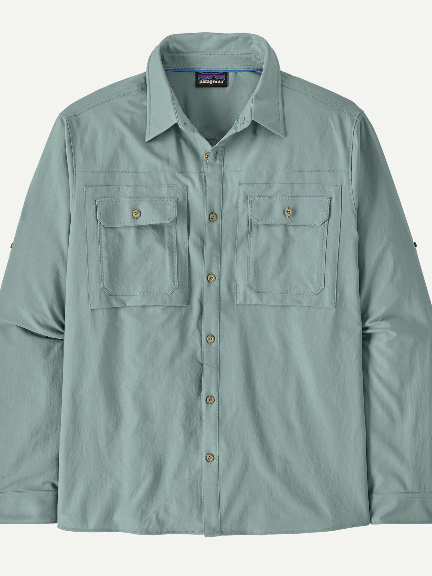 Light blue long-sleeve button-up shirt with two chest pockets, buttoned flaps, and a collar, displayed flat against a white background.