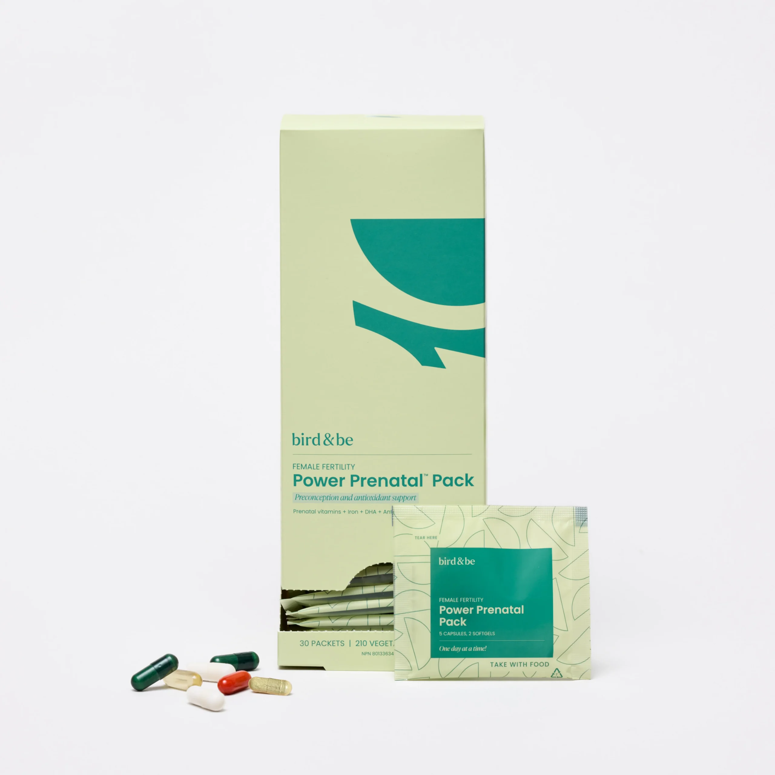 A box, packet, and assorted capsules of Bird & Be Power Prenatal Pack, a supplement for female fertility, are displayed on a white background.