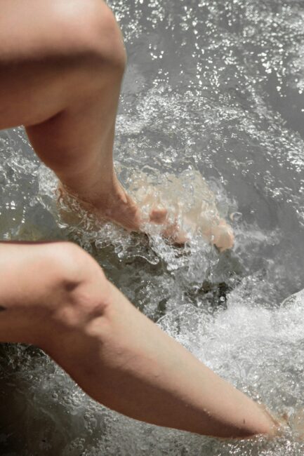 Legs and feet splashing in water.