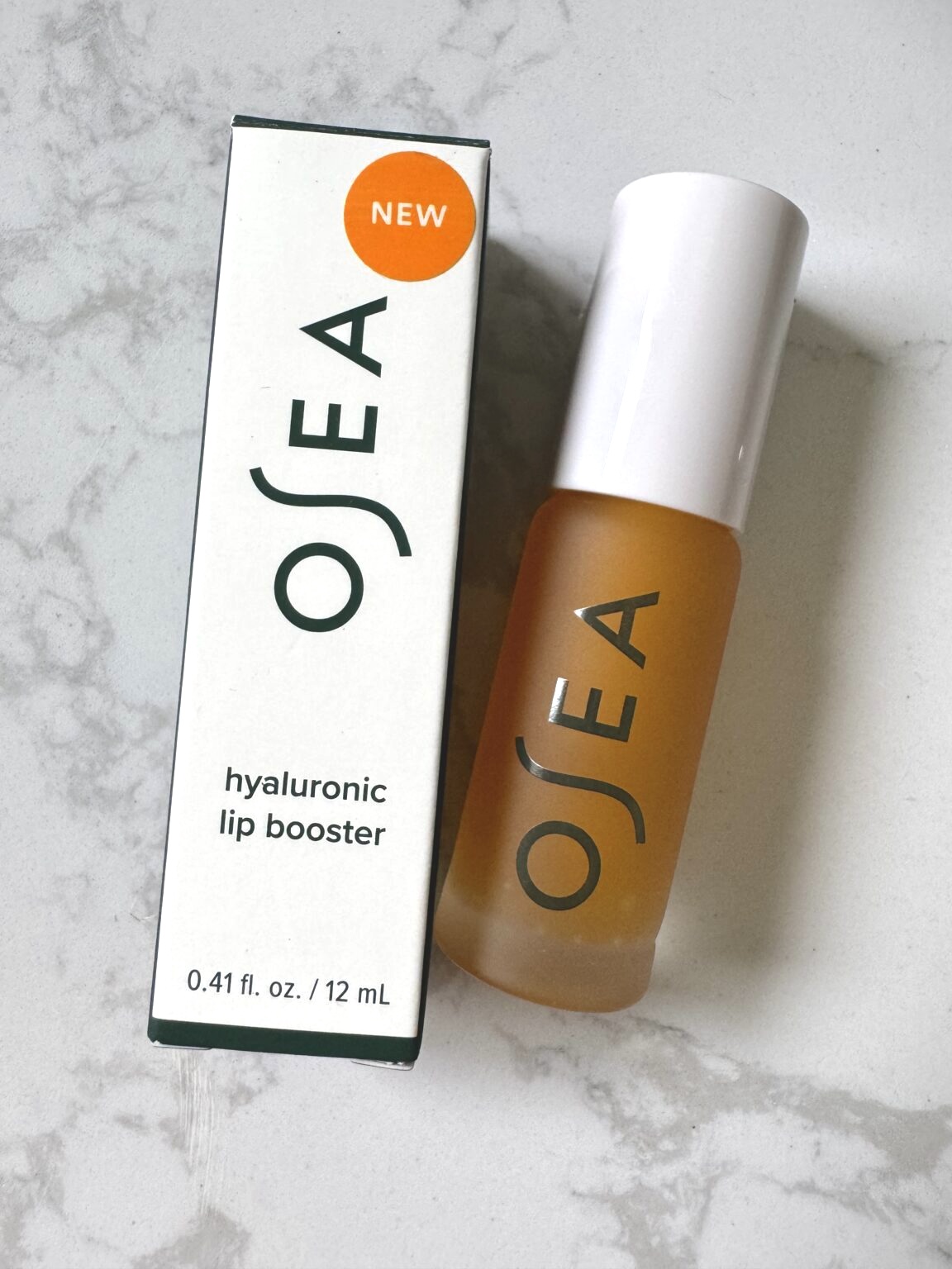 OSEA Hyaluronic Lip Booster product and its packaging box, labeled “NEW.”